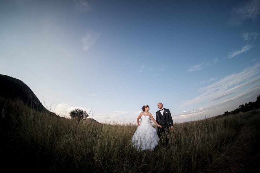 Garden Route wedding photography — candid couple moment in natural landscape by Tim Moolman